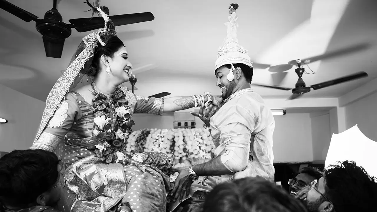 Candid moment from a Bengali wedding, capturing heartfelt emotions and traditional attire.