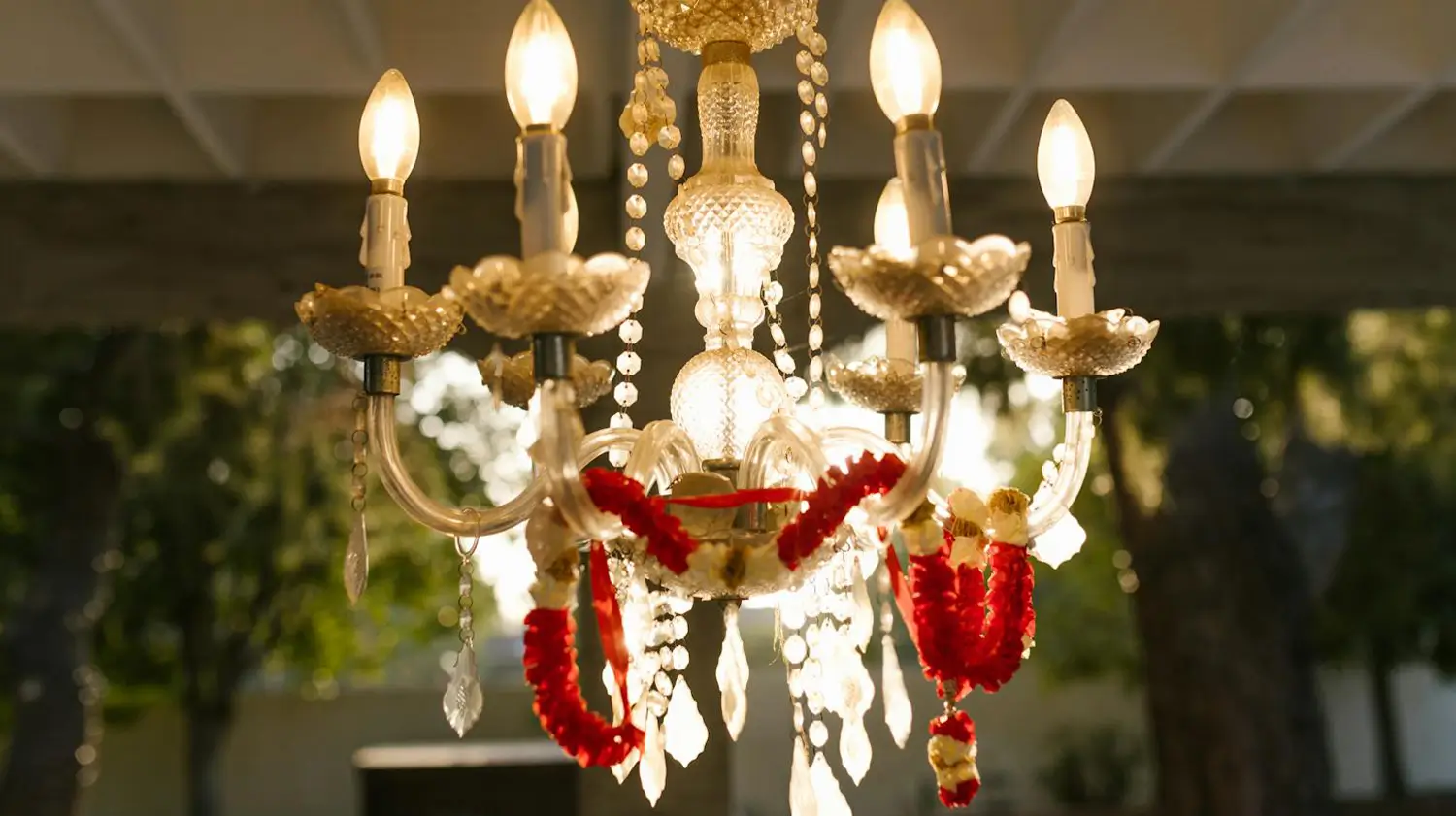 Elegant chandelier glowing at a wedding venue in Kolkata, West Bengal, adding a touch of luxury and charm to the decor.